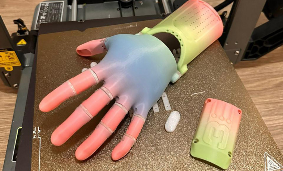 Menina conhece impressora 3D da Carreta da Inovação e recebe prótese de mão desenvolvida pelo Estado